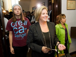 Andrea Horwath with son, in anti-woman, tee shirt